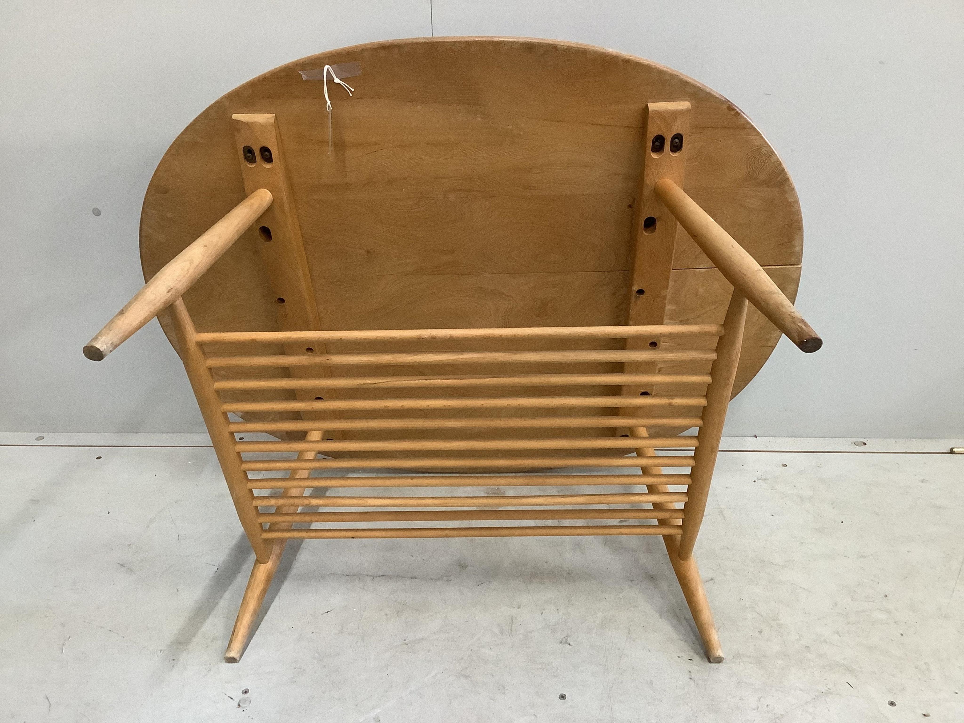 An Ercol oval elm coffee table and a nest of two tables, largest width 98cm, depth 84cm, height 44cm. Condition - poor